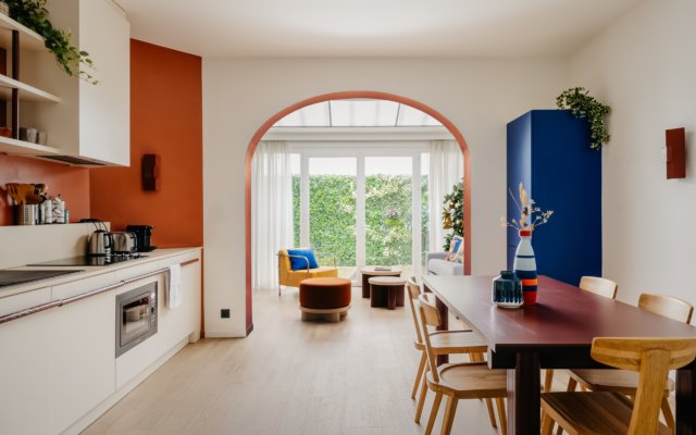 Vue panoramique sur la suite urbaine avec salon cuisine et salle à manger.